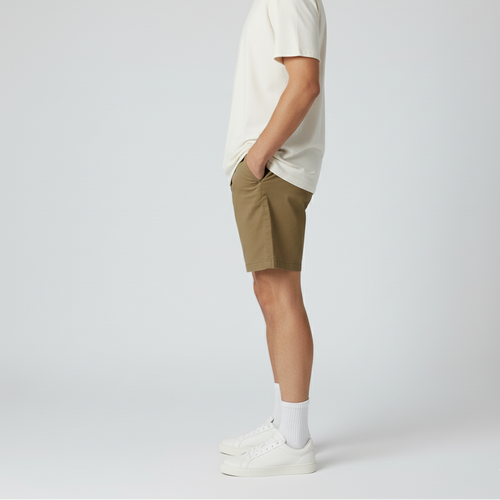 Person wearing a white t-shirt and beige shorts on a plain background